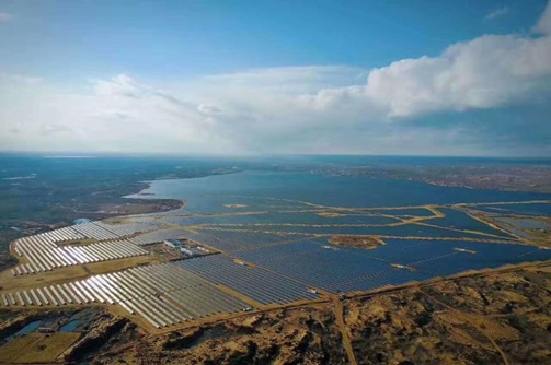 Two men in front of a solar field